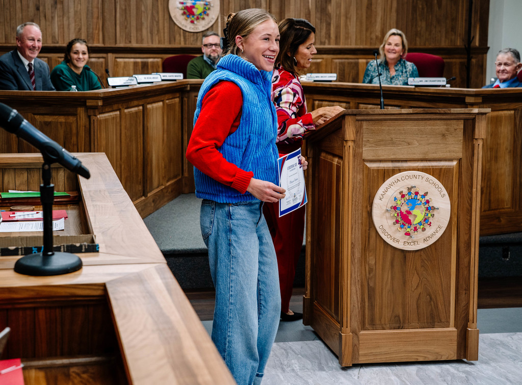 Maysen Fletcher smiling with her certificate.