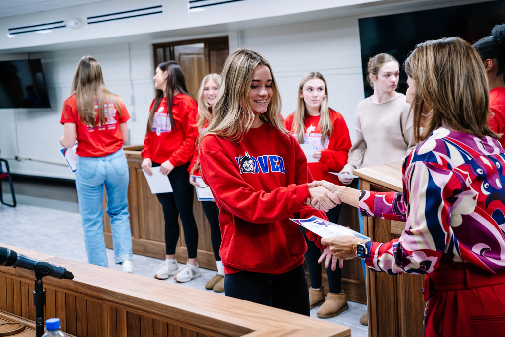 HHHS volleyball player walking up to get her certificate at the kcs board of education meeting.