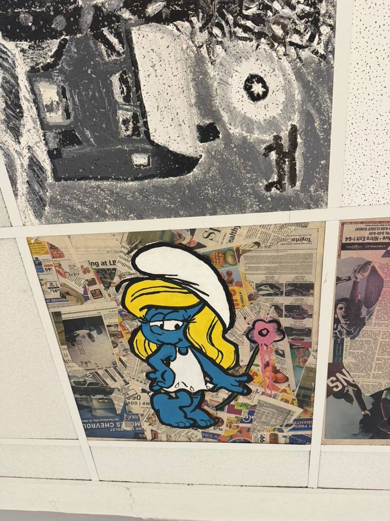 A ceiling tile in the hallway at West Side Middle School has been painted with picture Mrs. Smurf by art students.
