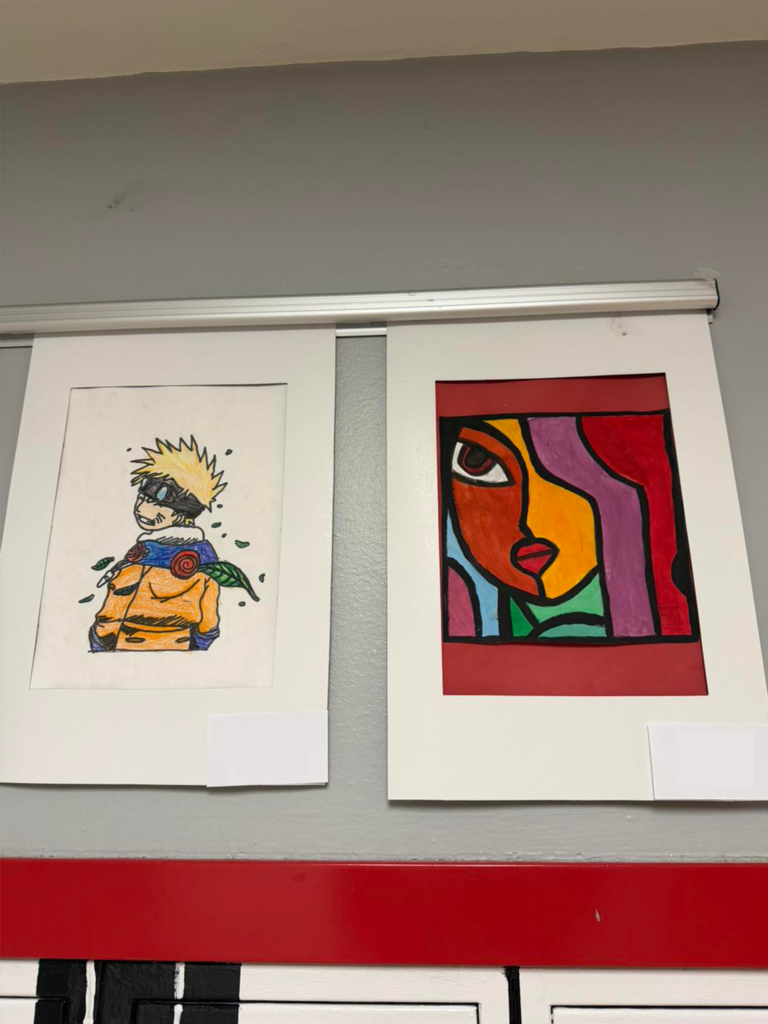 Two pieces of student art hanging in the hallway at West Side Middle School.