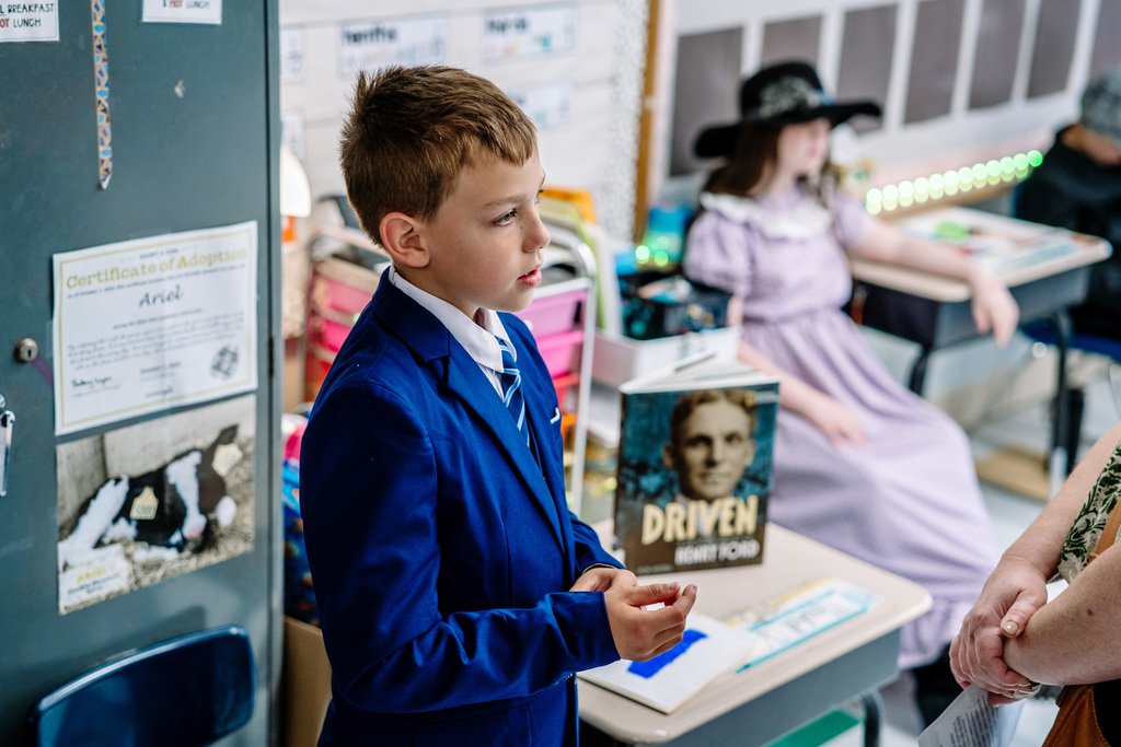 A student dresses as Henry Ford, speaking during his presentation. 