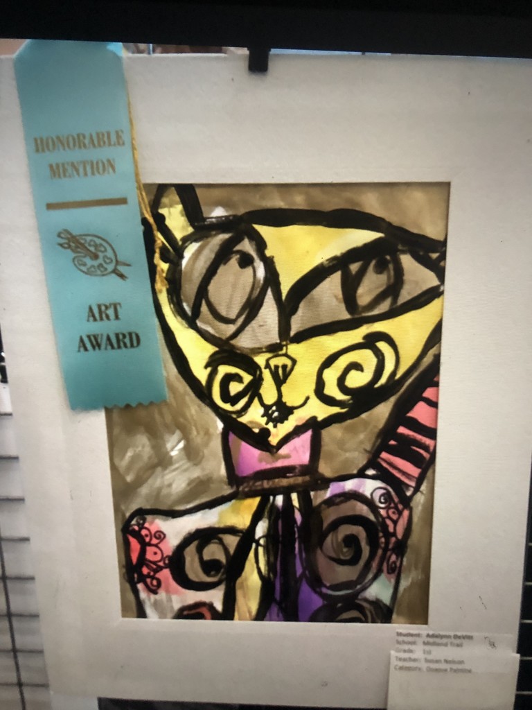 Colorful abstract cat painting with swirling patterns in yellow and brown, framed and displaying a blue "Honorable Mention Art Award" ribbon.