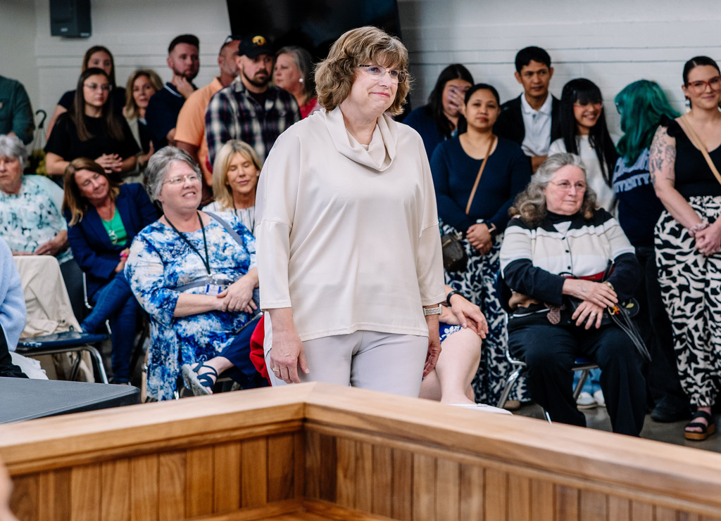 2026 KCS Counselor of the Year, Emily Patterson, is walking up to the front of the board room to receive her award.