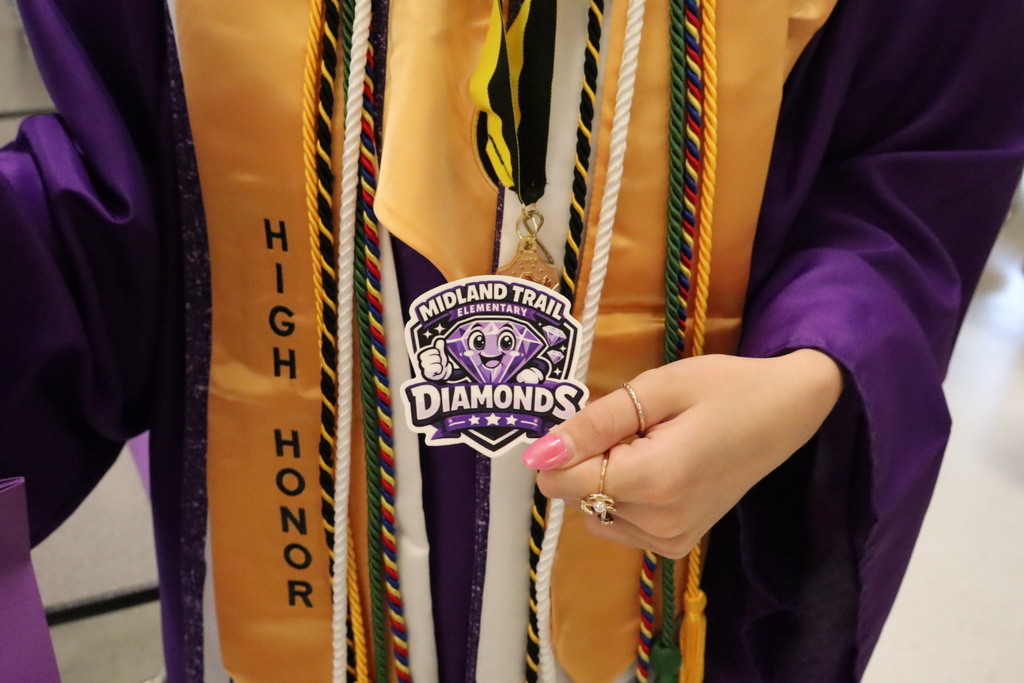 Student holding a  Diamond sticker.