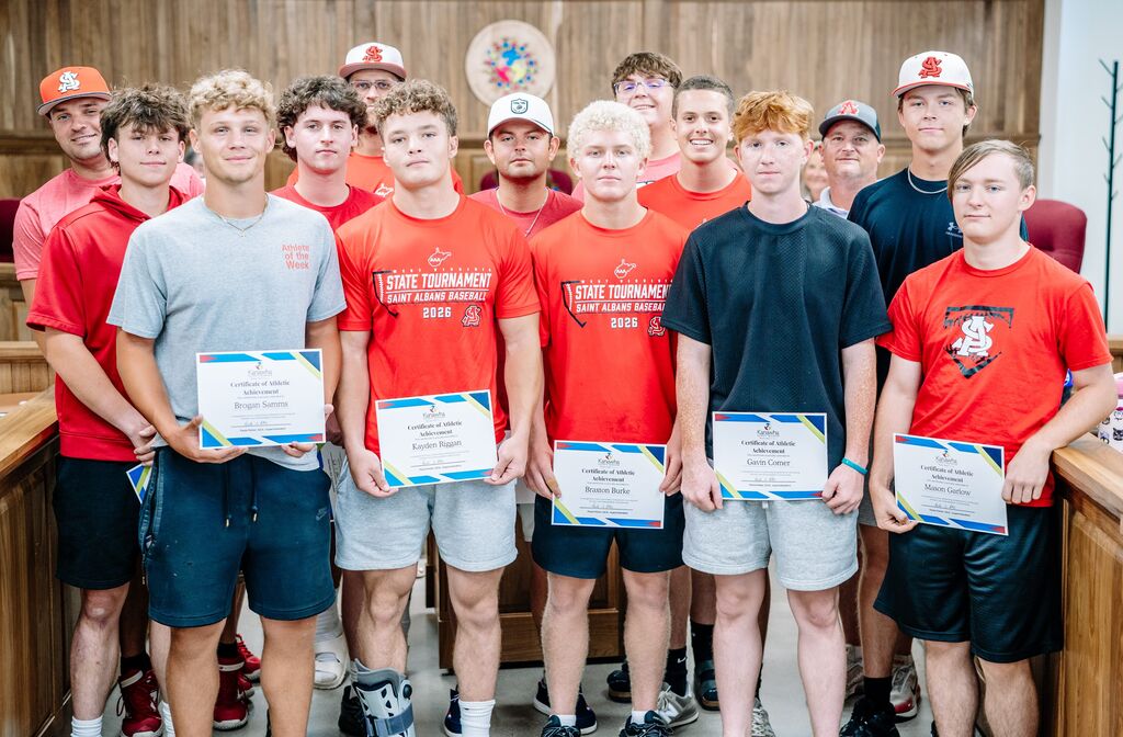 St. Albans High School baseball team holding certificates and posing for a picture in the KCSBOE meeting room.