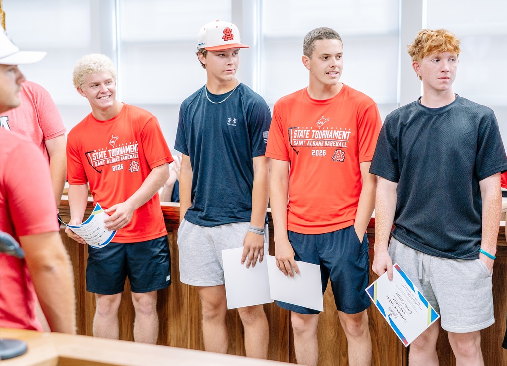 St. Albans baseball players smiling was they watch their teammate called up to the podium to receive a certificate.