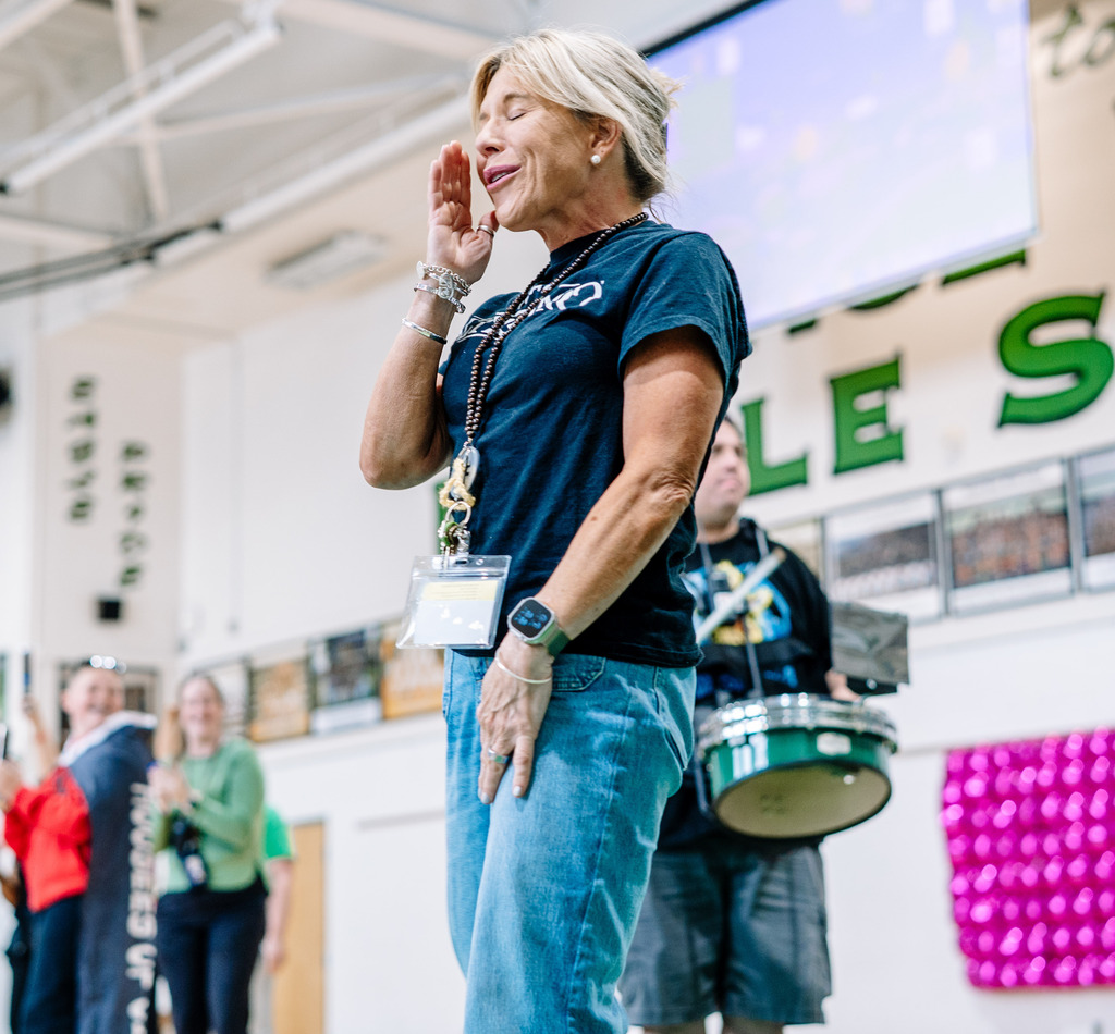 Shandon Tweedy, wiping away a tear from her face, in the school's gym.