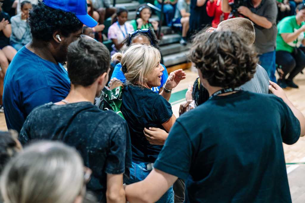 Shandon Tweedy surrounded by students congratulating her.