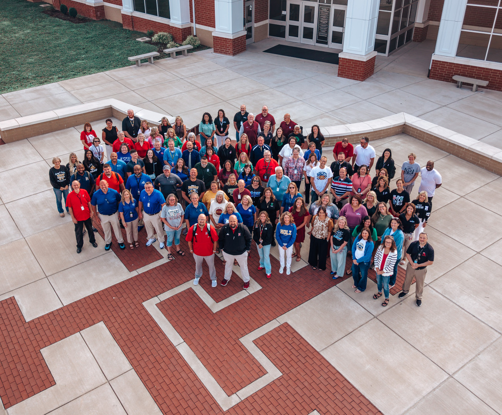 Aerial photo of the all KCS administrators. They are standing outside the front entrance of Herbert Hoover High School.