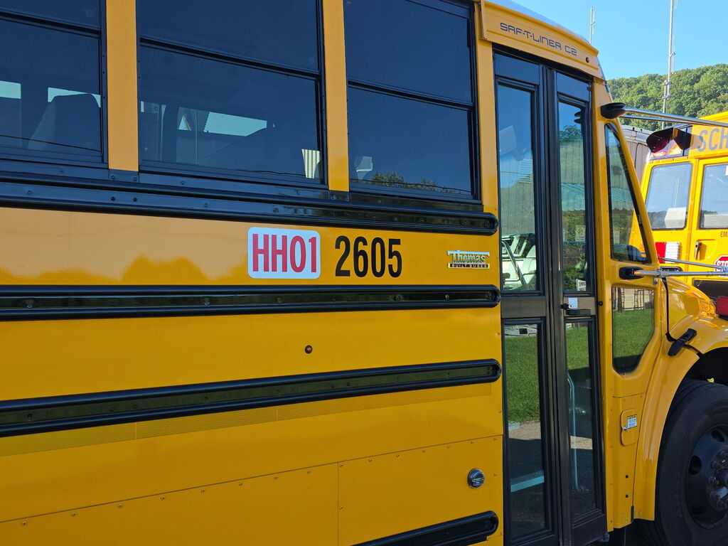 School bus 2605 with HH01 route number on the side of the bus. 