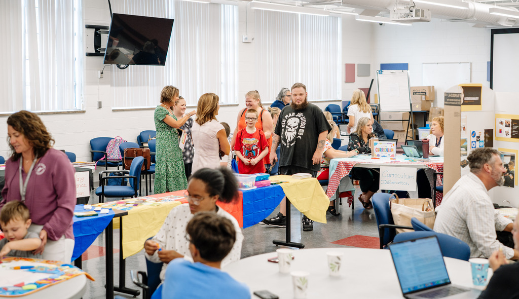 Families walking around the OES open house event at the Edison Staff Development Center.