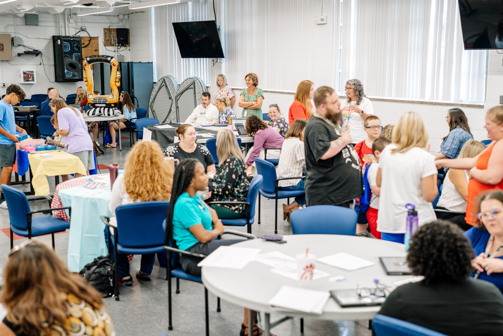 Families  and KCS employees talking during the open house.