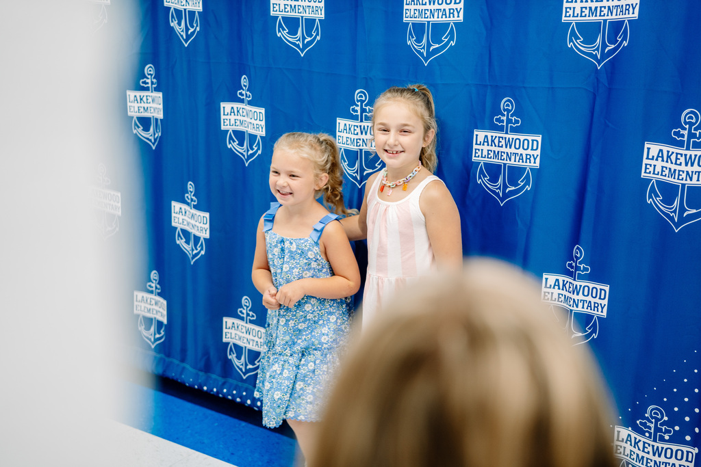 Two students standing in front of a a backdrop at Lakweood Elementary