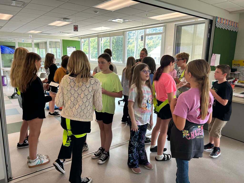 A group of students standing in two circles facing each other.