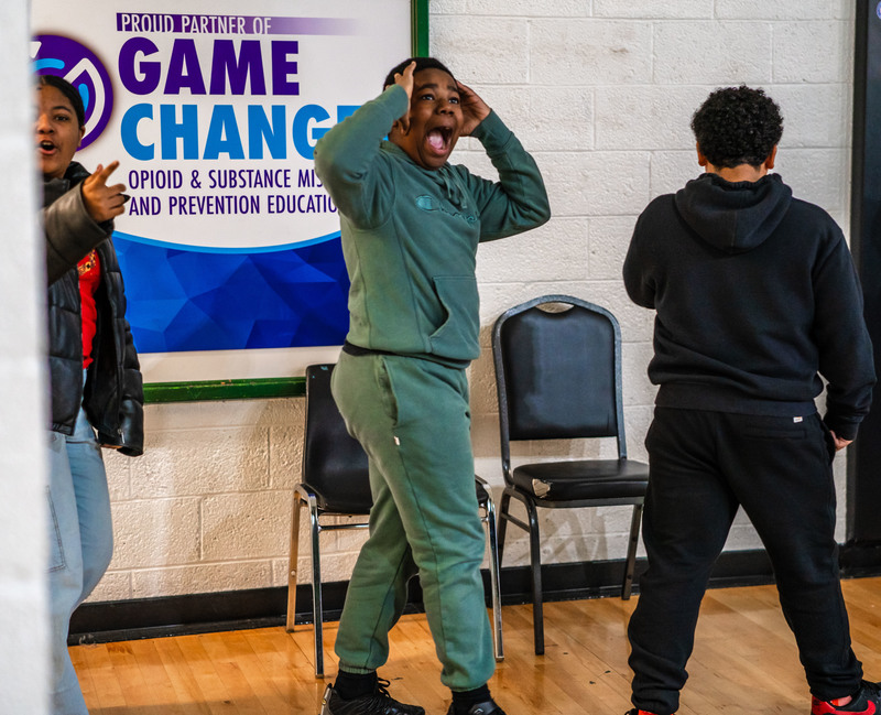 A student reacting in shock and surprise after seeing the setup for the school event.