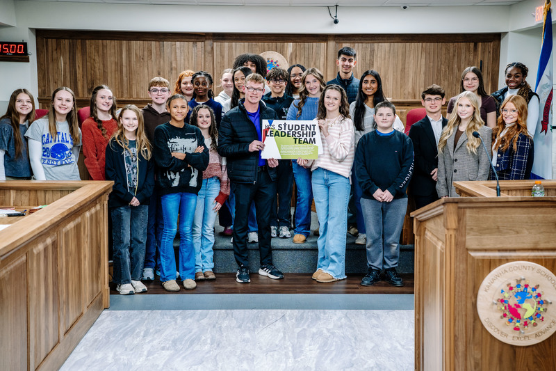KCS student leadership team posing for a picture in the KCS board room.