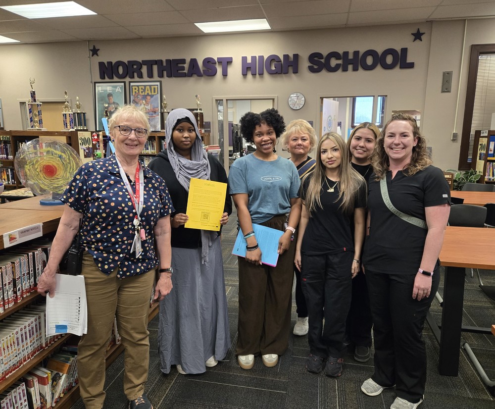 Team of nurses and NEHS student