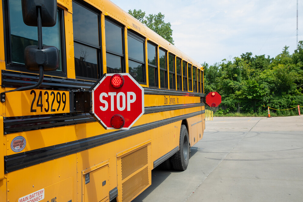 A school bus with the stop signs flared out