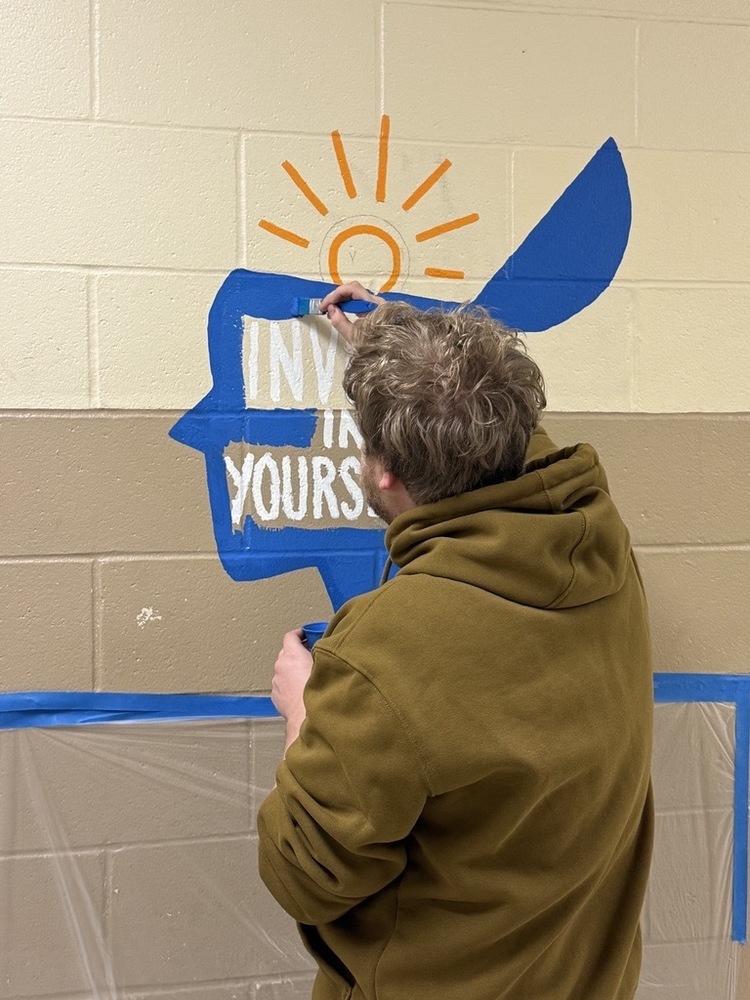 Volunteer painting MLK Day of Service mural