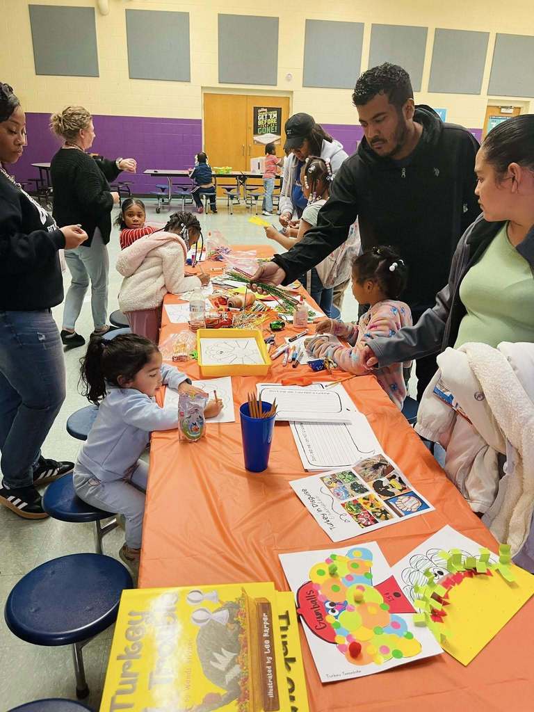 Parents and students doing reading exercises at Banneker Literacy Night.