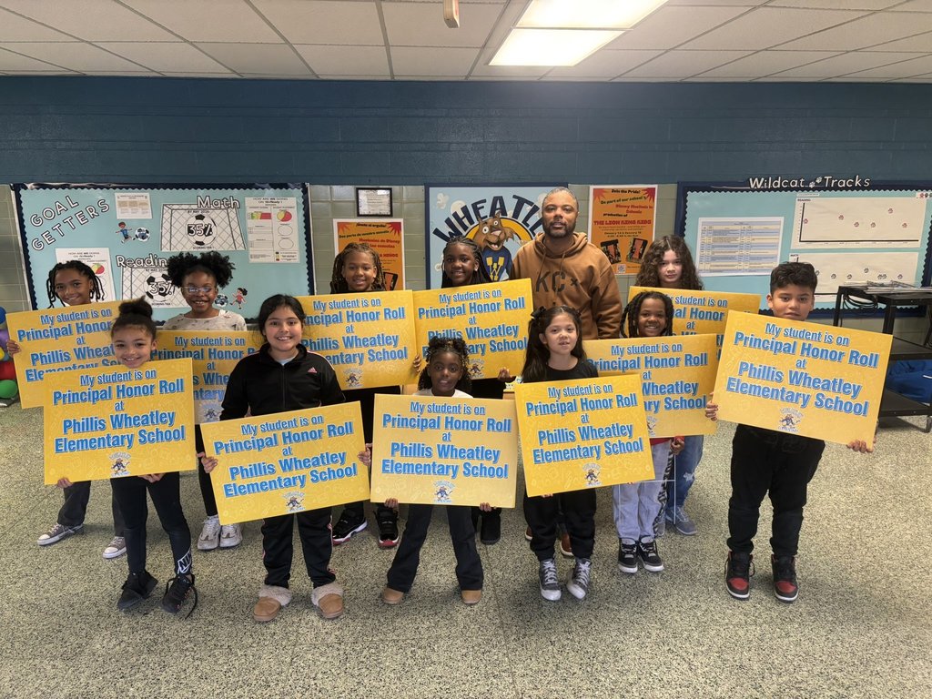 Principal Honor Roll students gathered around with Principal Edwards with their yard signs