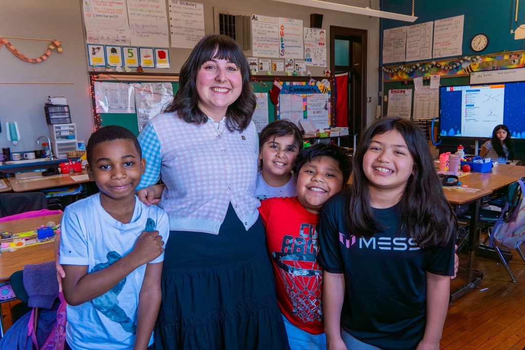 Teacher of the Year stands with her students.
