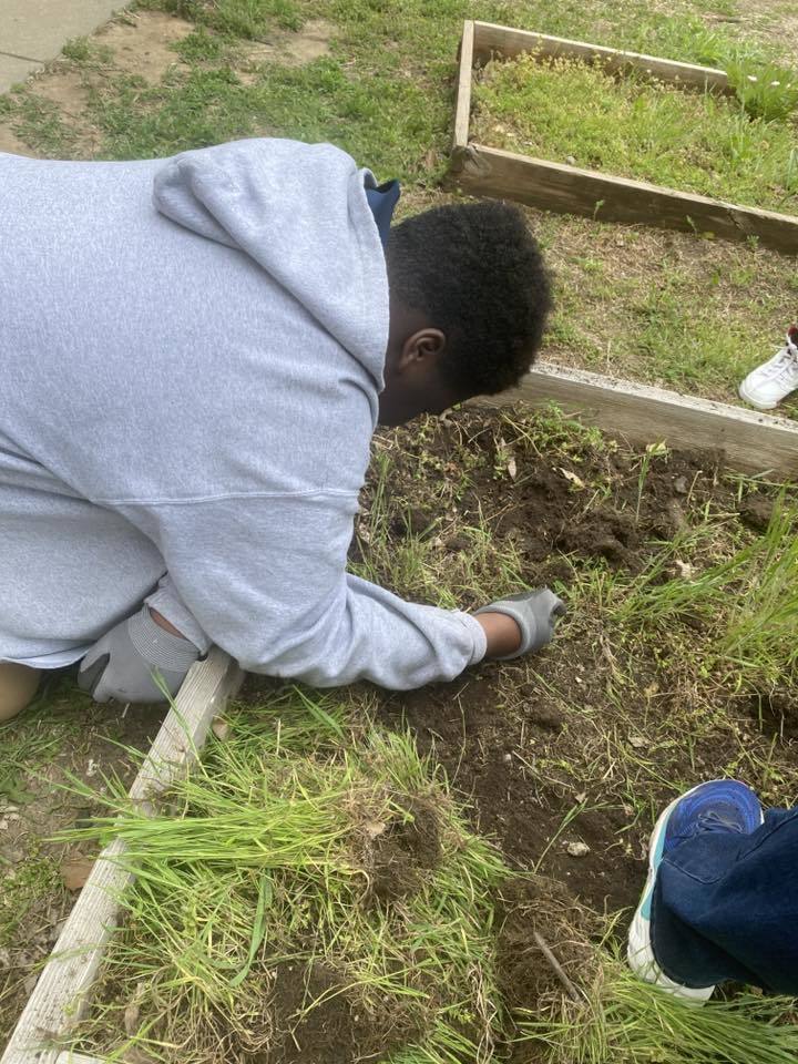 student planting for Earth Day