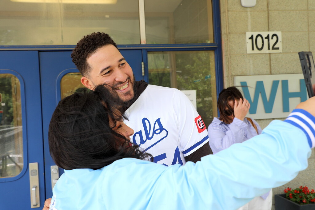 Baseball player Carlos Estevez smiles for a photo with a member of the Royals Literacy League