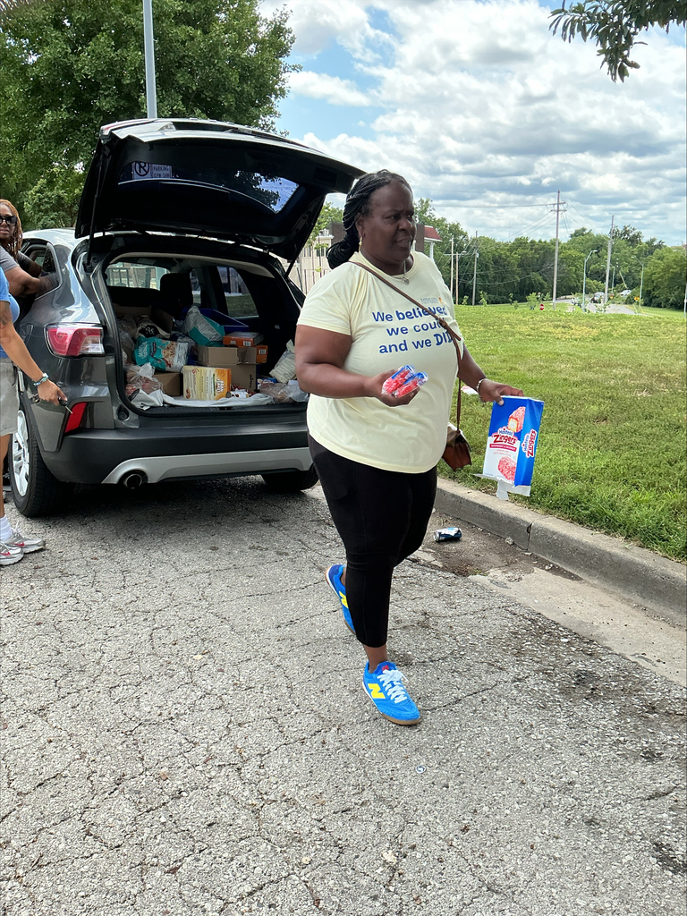 KCPS Family & Community Engagement Liaisons out in the community during summer break, interacting with family and students. The team is handing out pantry staples and ice cream to support and connect with the community.
