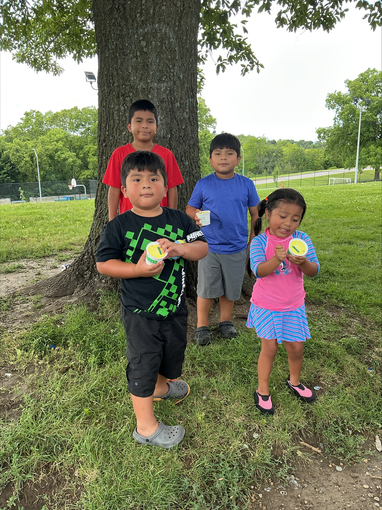 KCPS Family & Community Engagement Liaisons out in the community during summer break, interacting with family and students. The team is handing out pantry staples and ice cream to support and connect with the community.