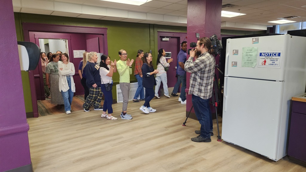 More than a dozen teachers walk through the newly renovated teacher's lounge at Northeast Middle School