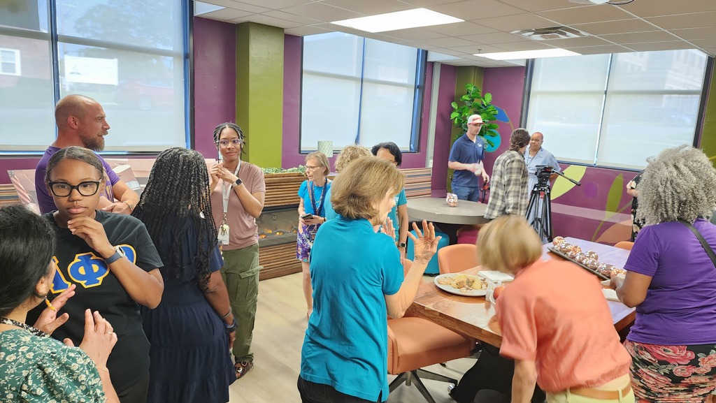 More than a dozen teachers walk through the newly renovated teacher's lounge at Northeast Middle School