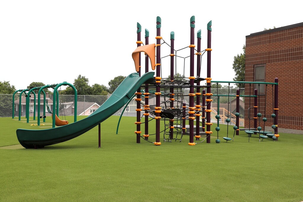 bright green grass sits underneath a new playset at gladstone elementary