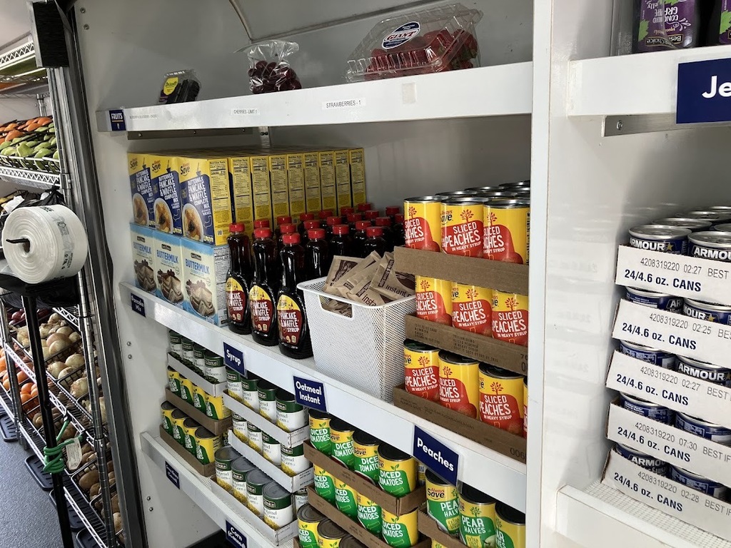 a pantry shelf stocked full of canned and other non-perishable goods