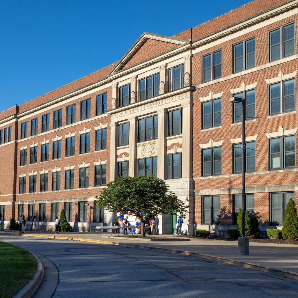 a tall brick building with four stories of windows