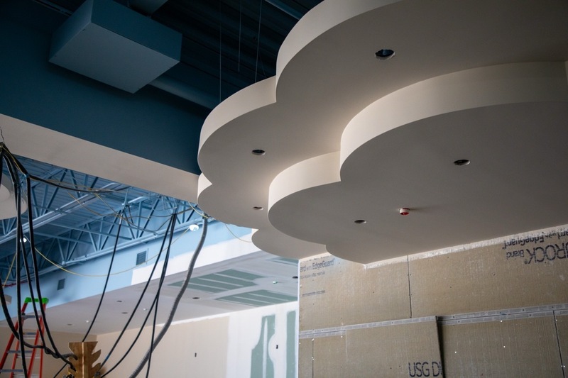 a photo of a school still under construction with a ceiling element modeled to look like a cloud in the sky