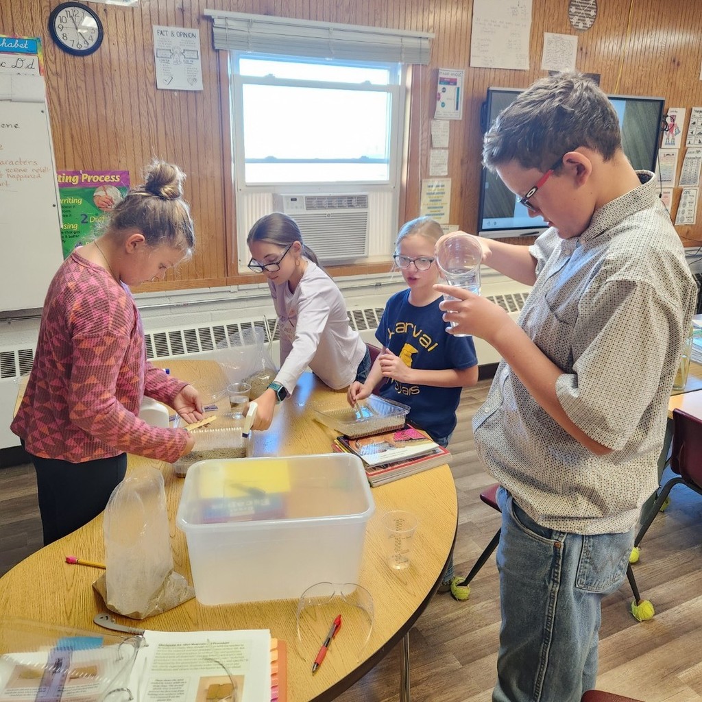 students conduct a science experiment in the classroom