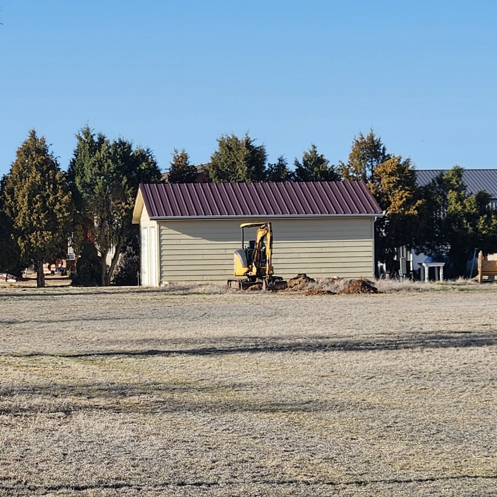 backhoe sits on a site for a new home.