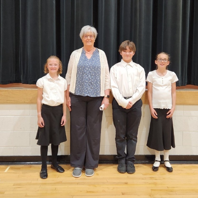 students and teacher pose
