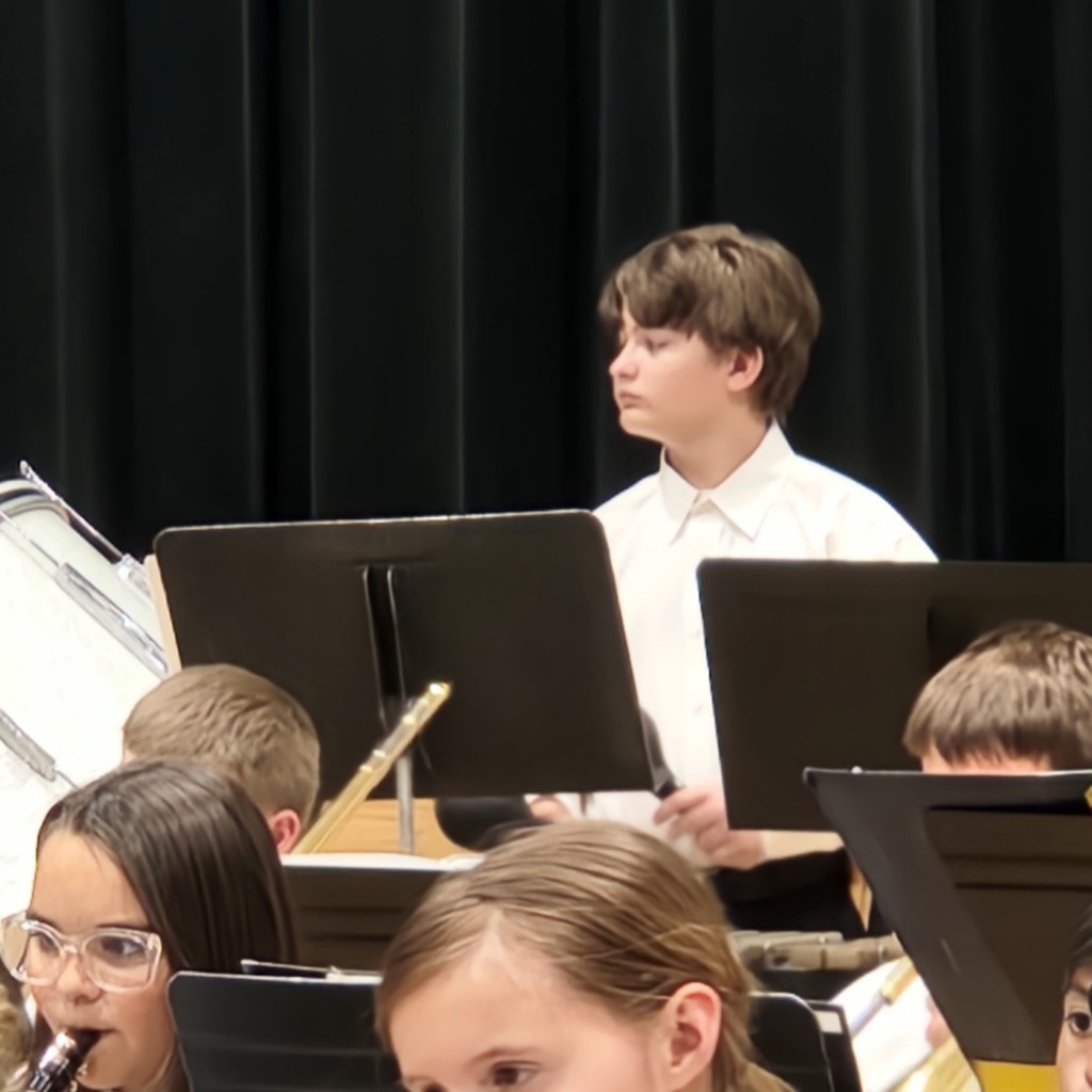 student plays percussion