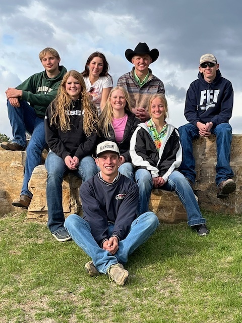 Rural students pose on haybales.