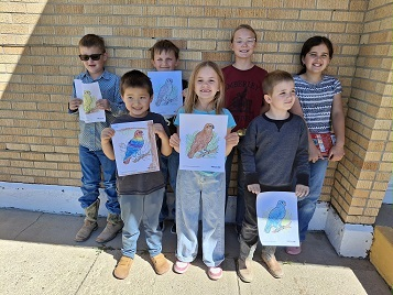 Some of our elementary students proudly displaying their coloring skills for the Plover Festival coloring contest.