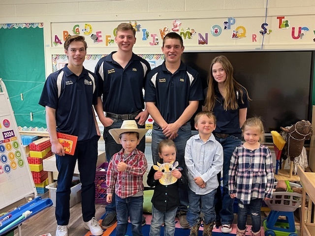 FFA members pose with preschoolers for FFA Ag in the Classroom.