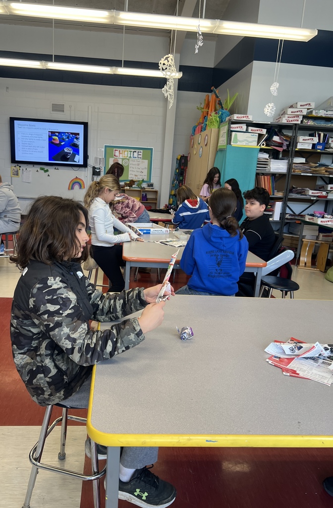 students making projects sitting at desks 