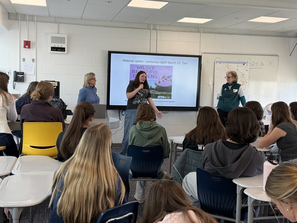 students in classroom listening to student with a microphone