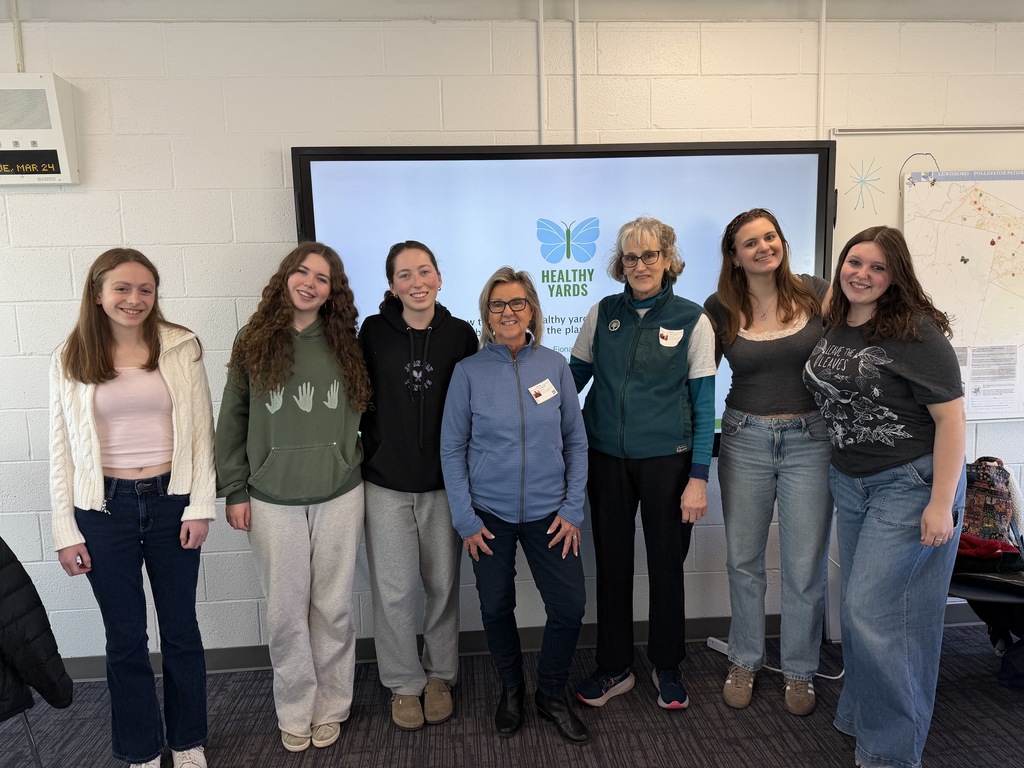 students standing in front of screen
