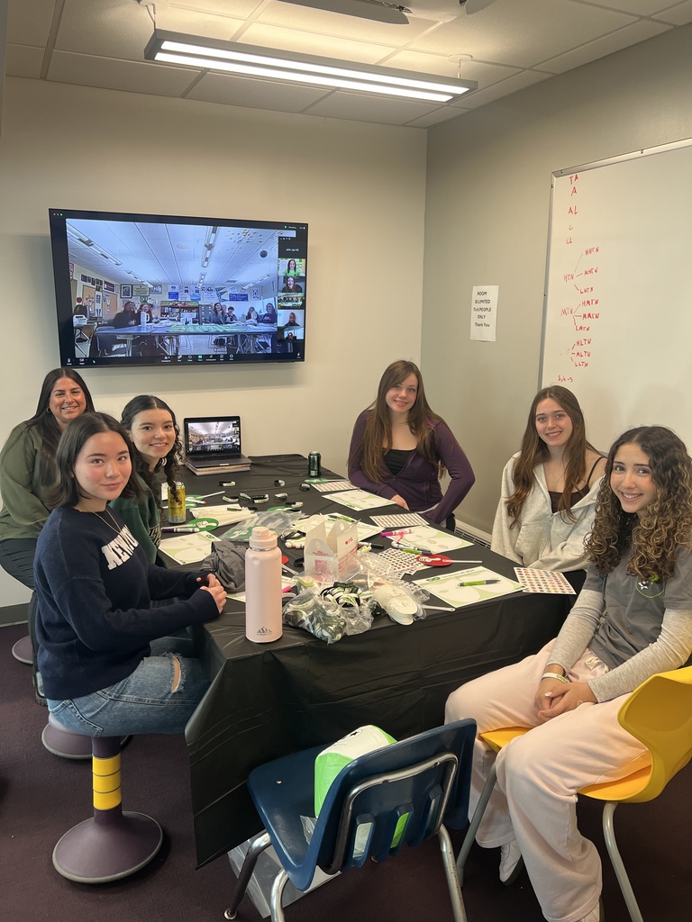 students sitting at table smiling 