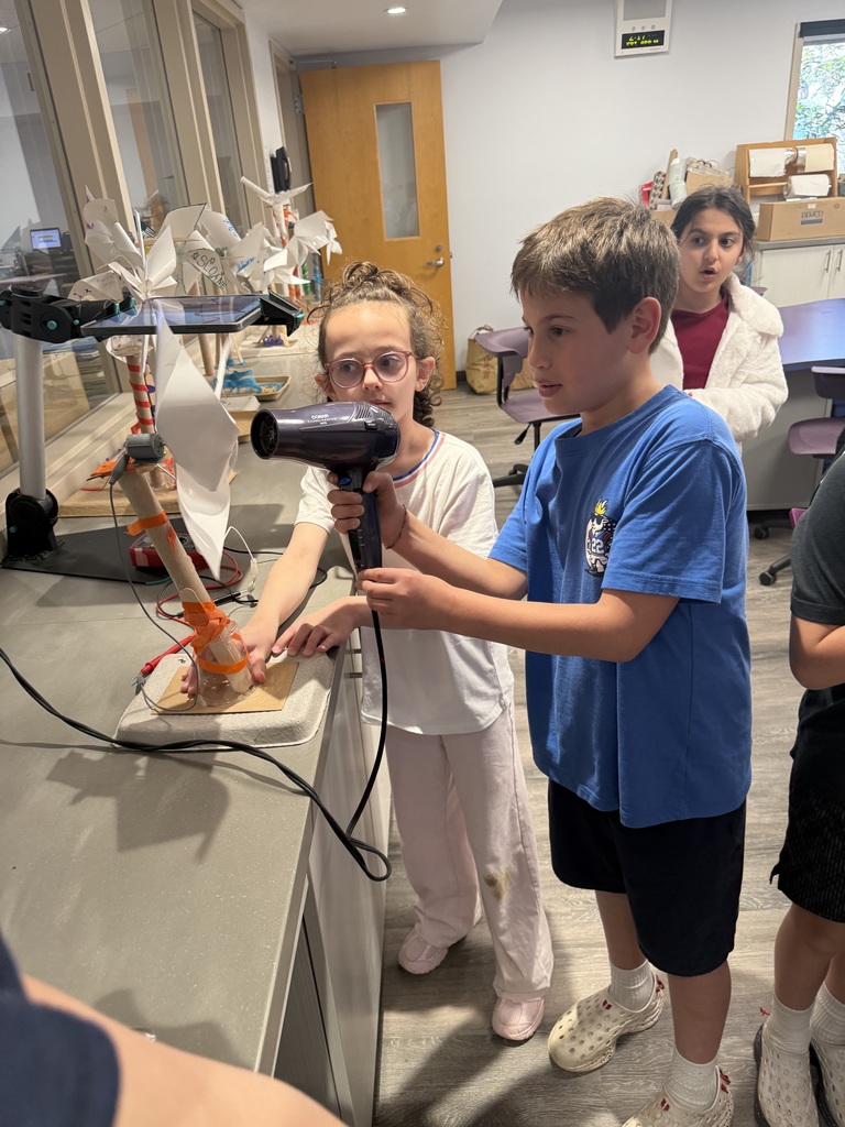 students standing making windmills
