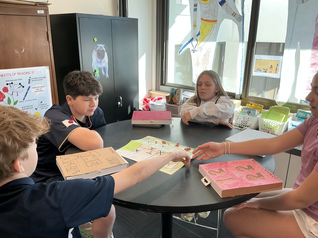students sitting at desk playing game