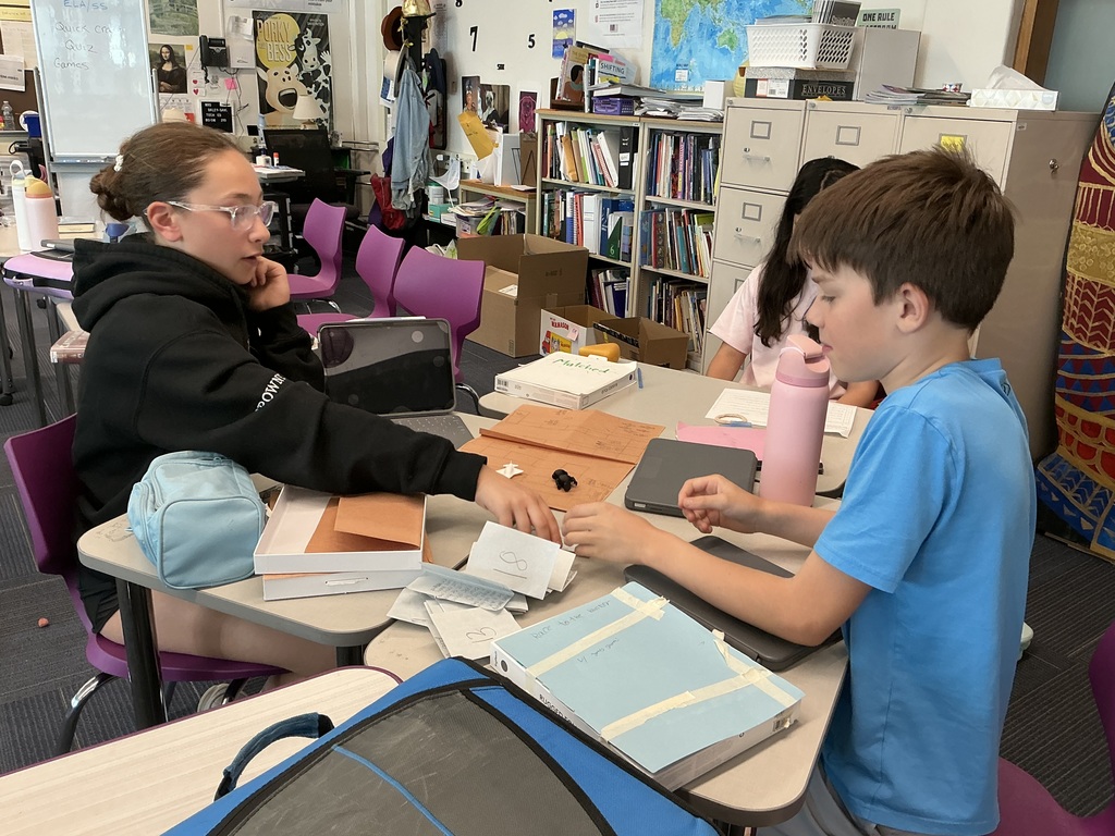 students sitting at desk playing game